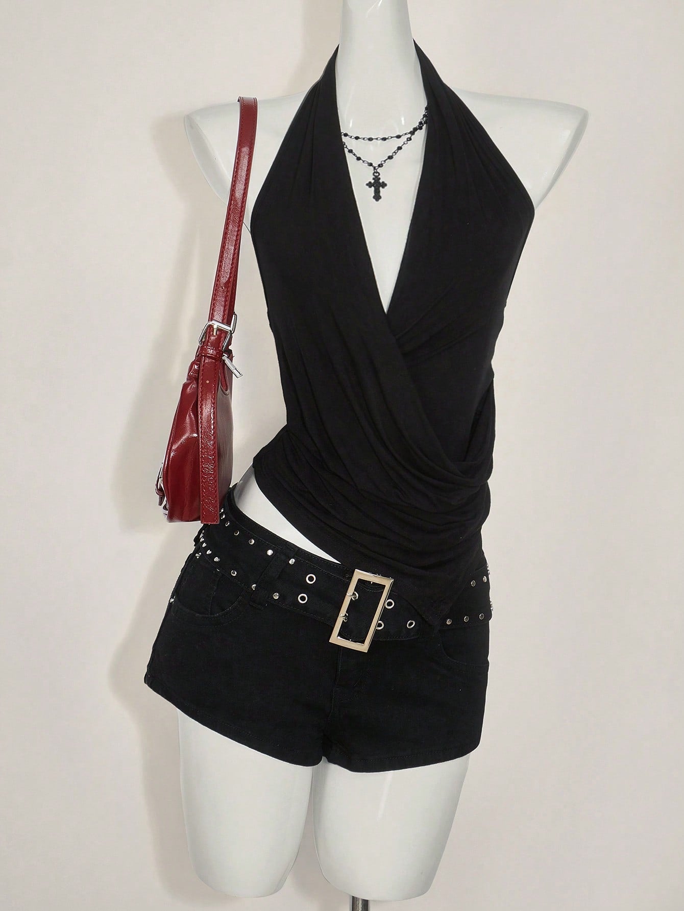 Women's asymmetrical hem halter tank top with draped neckline, backless wrap styling, and grommet eyelet details