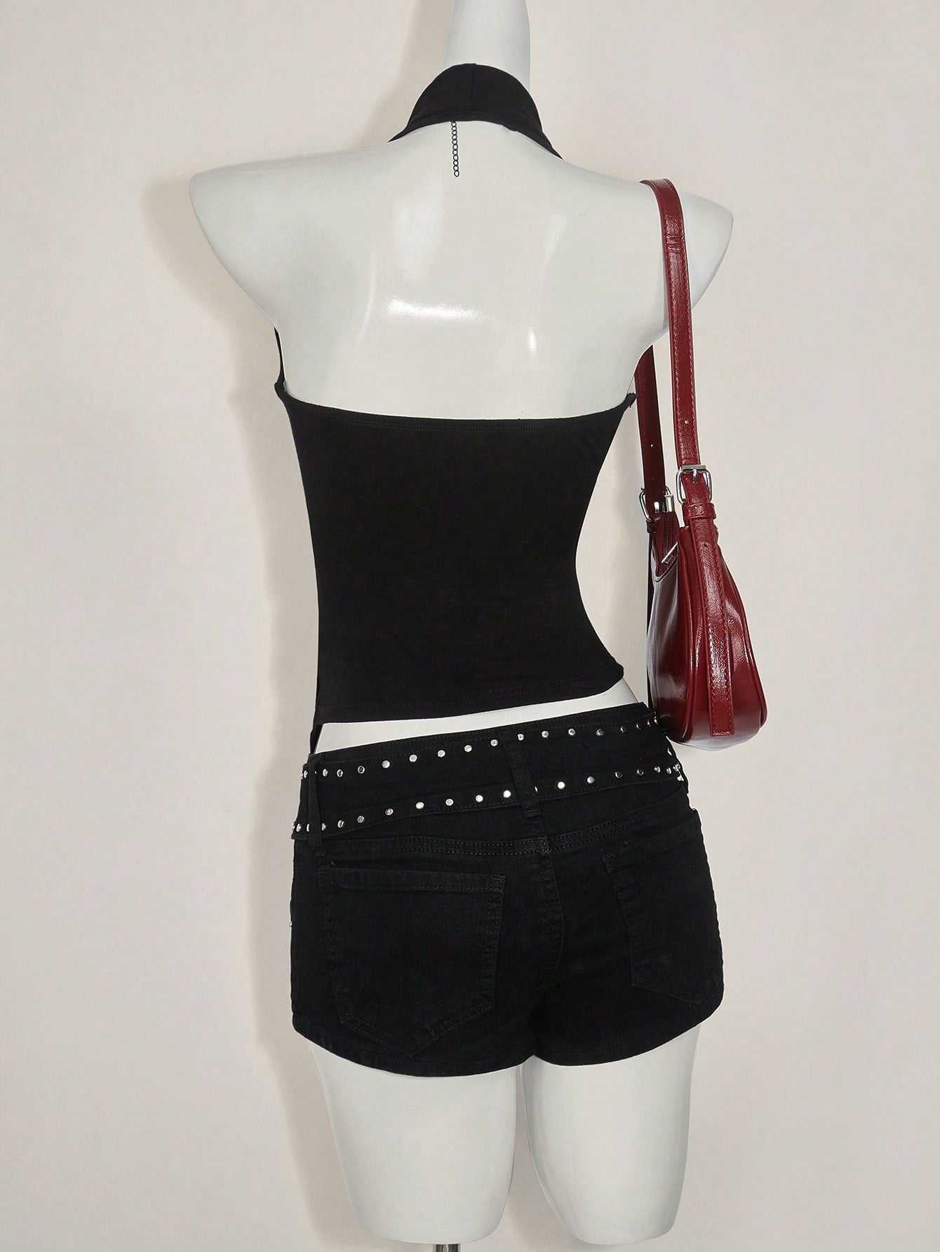 Women's asymmetrical hem halter tank top with draped neckline, backless wrap styling, and grommet eyelet details