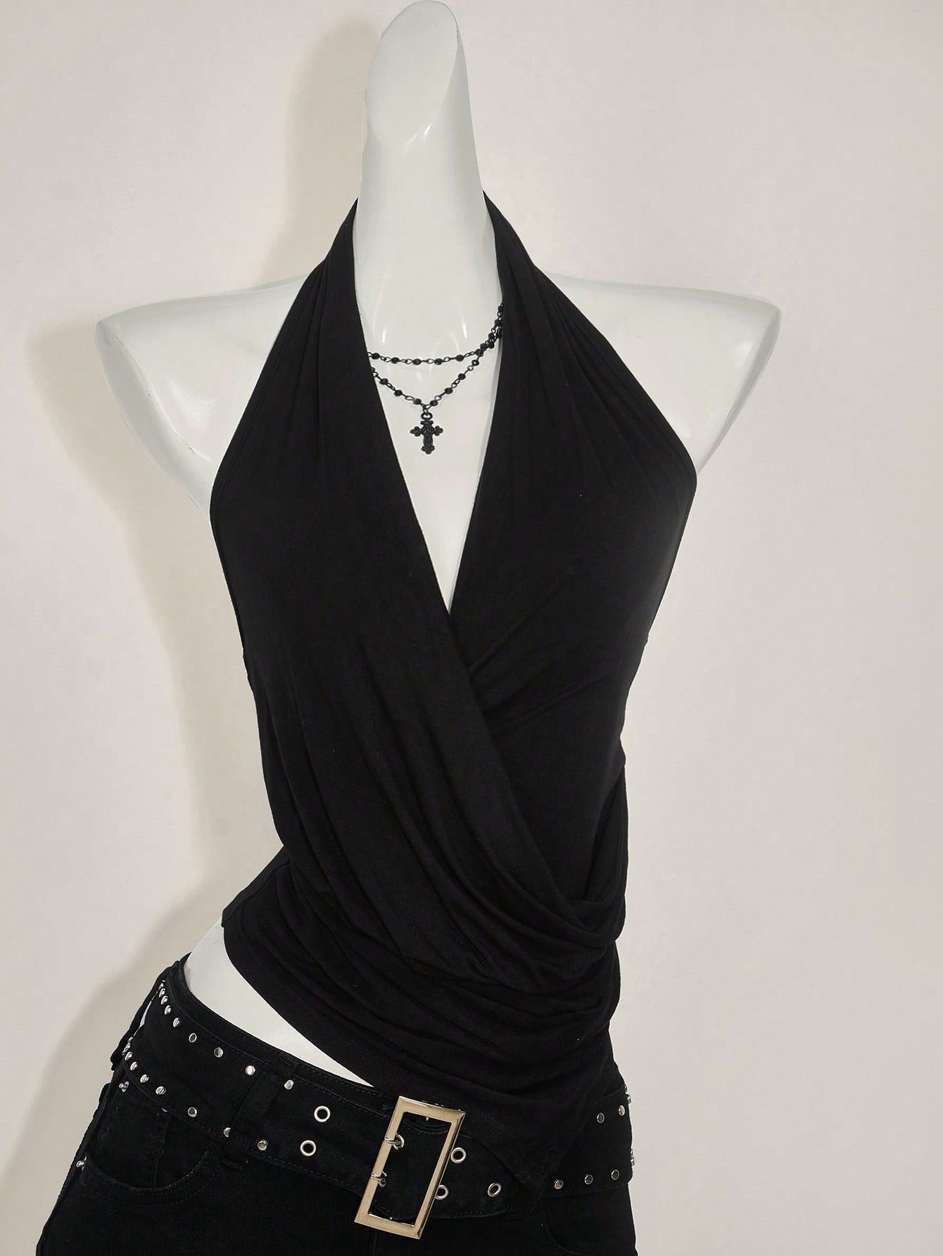 Women's asymmetrical hem halter tank top with draped neckline, backless wrap styling, and grommet eyelet details