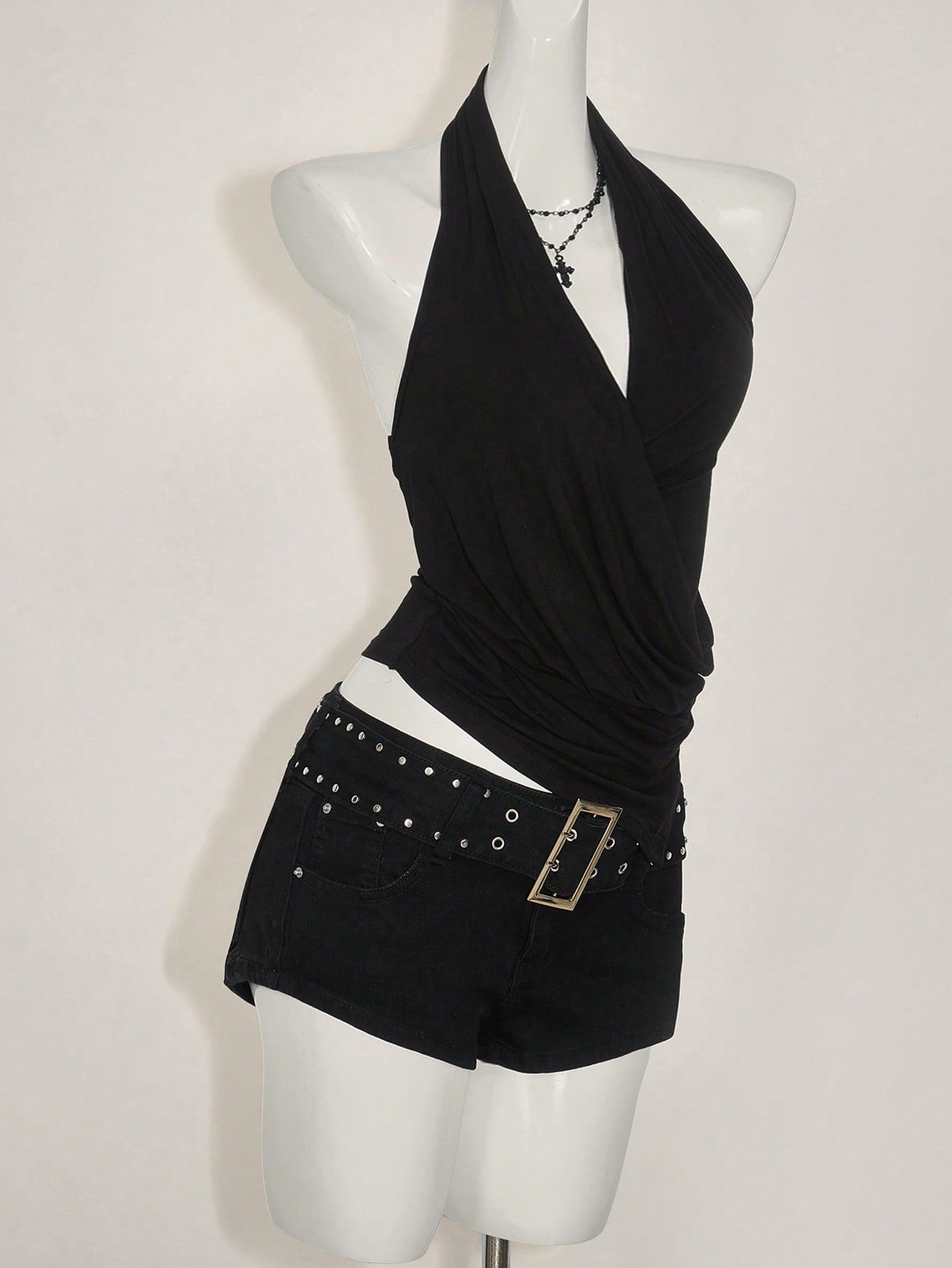 Women's asymmetrical hem halter tank top with draped neckline, backless wrap styling, and grommet eyelet details