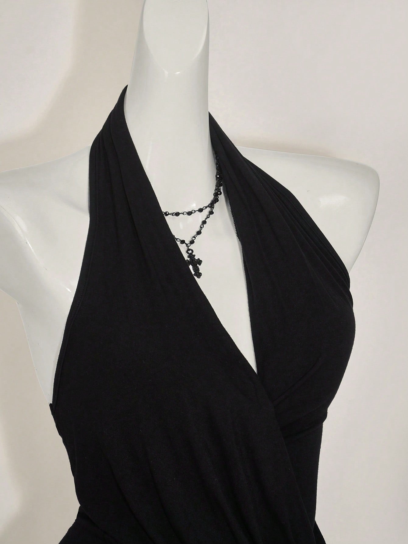 Women's asymmetrical hem halter tank top with draped neckline, backless wrap styling, and grommet eyelet details