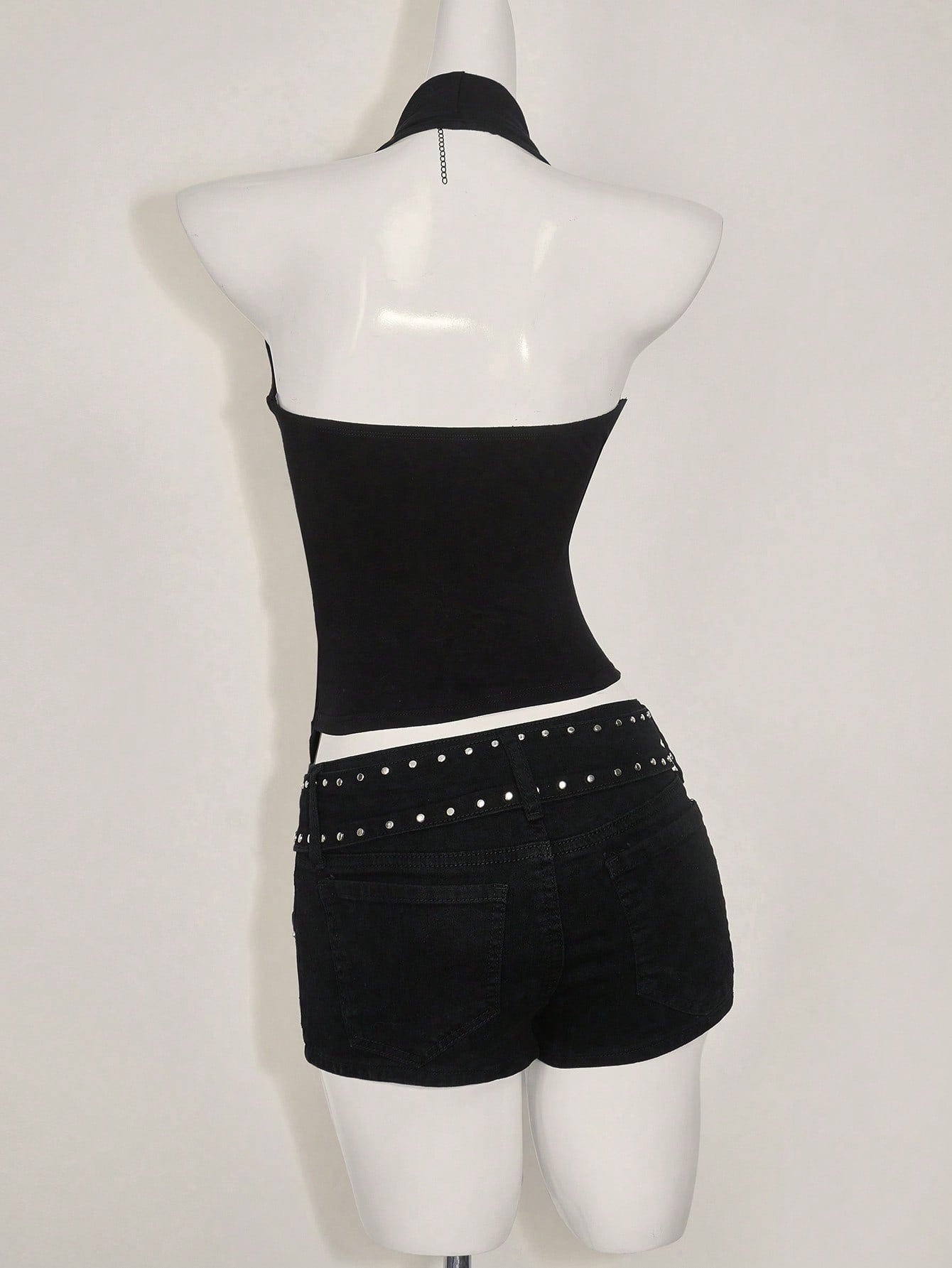 Women's asymmetrical hem halter tank top with draped neckline, backless wrap styling, and grommet eyelet details