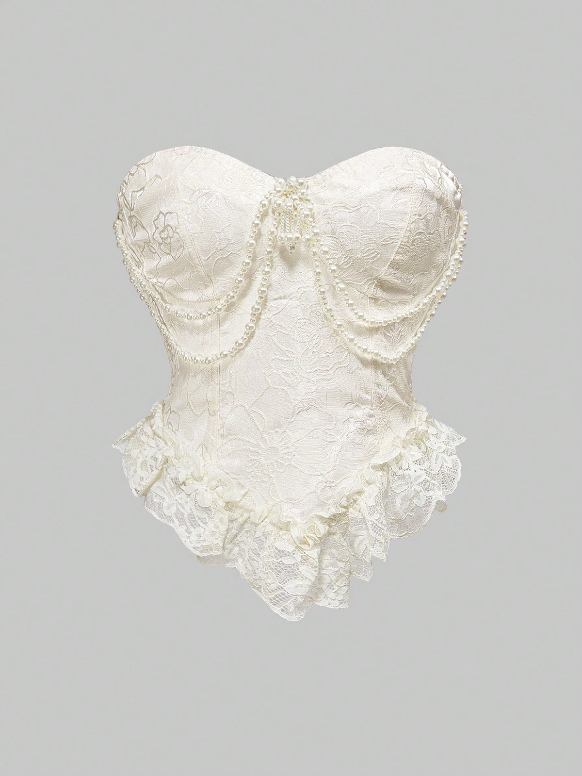 Women's apricot strapless vintage palace style blouse featuring an asymmetrical ruffle hem, backless design, and pearl brooch detail.