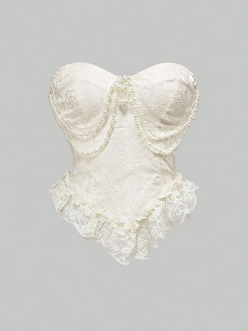 Women's apricot strapless vintage palace style blouse featuring an asymmetrical ruffle hem, backless design, and pearl brooch detail.