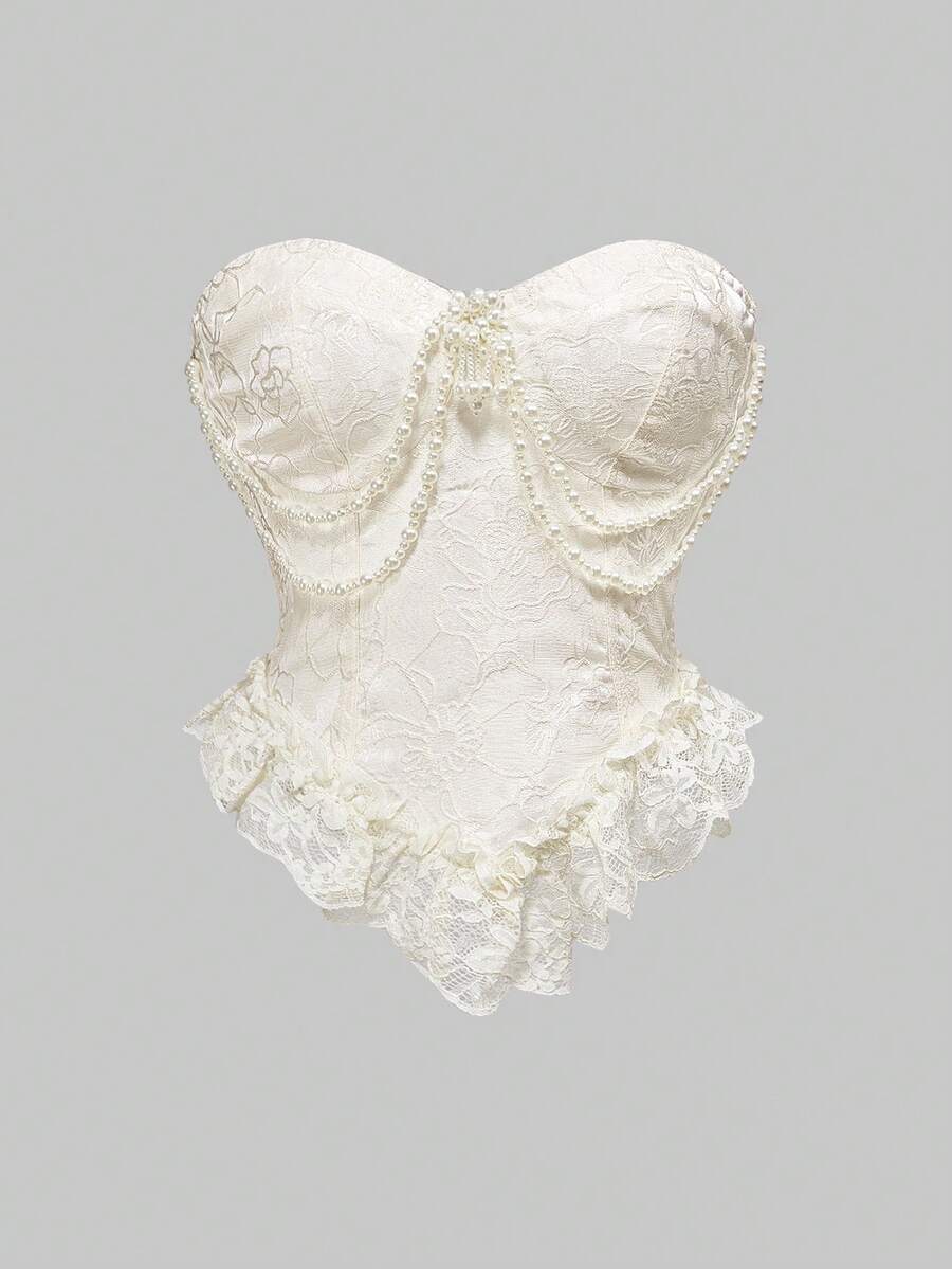 Women's apricot strapless vintage palace style blouse featuring an asymmetrical ruffle hem, backless design, and pearl brooch detail.