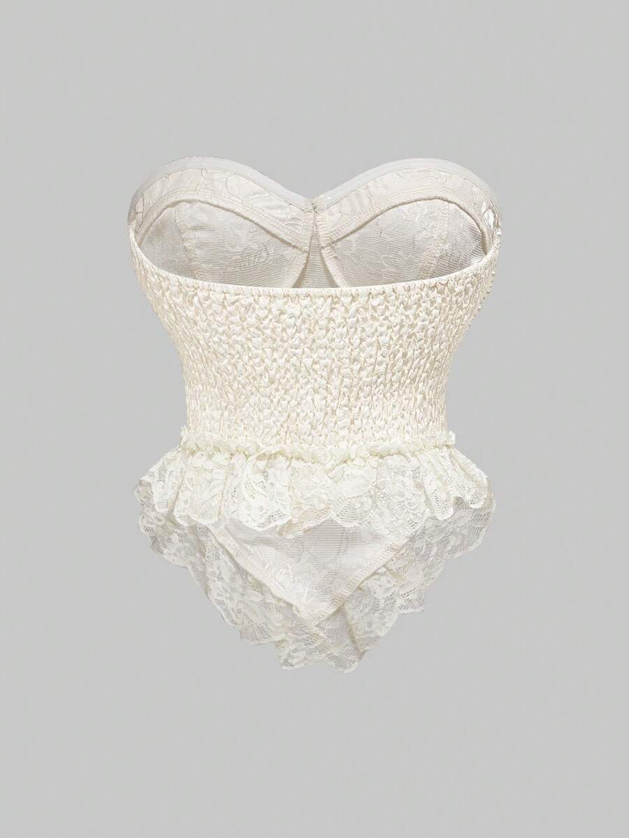 Women's apricot strapless vintage palace style blouse featuring an asymmetrical ruffle hem, backless design, and pearl brooch detail.