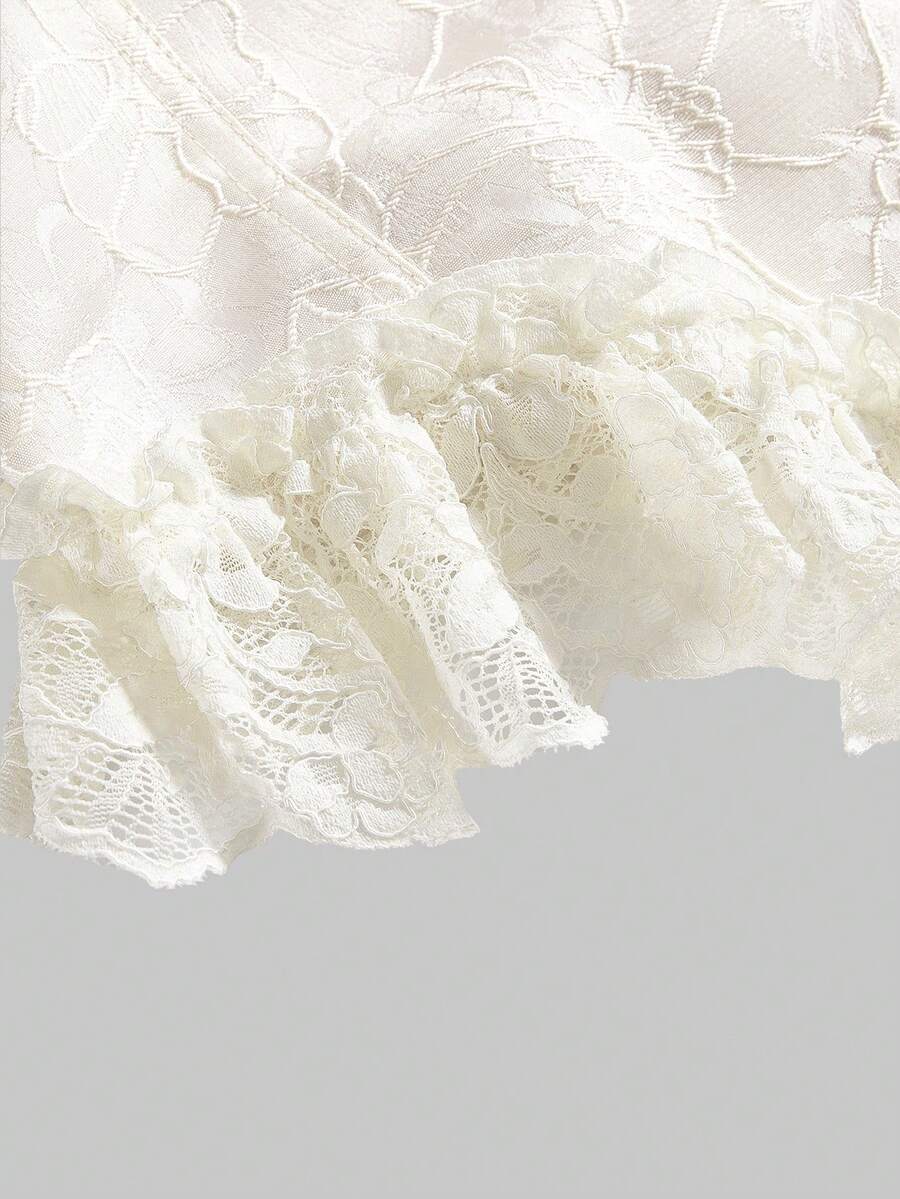 Women's apricot strapless vintage palace style blouse featuring an asymmetrical ruffle hem, backless design, and pearl brooch detail.