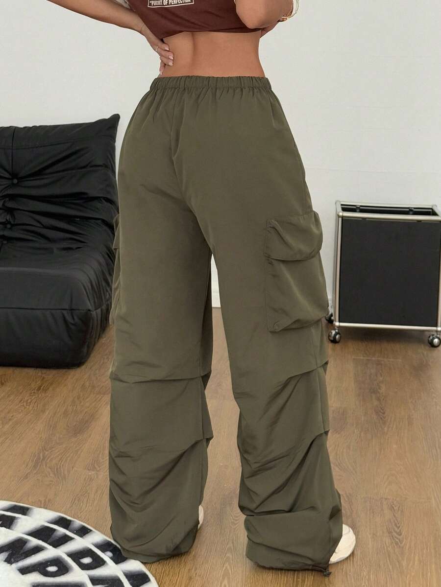 Women's loose fit parachute cargo pants featuring a drawstring waist and functional pockets in a casual streetwear style