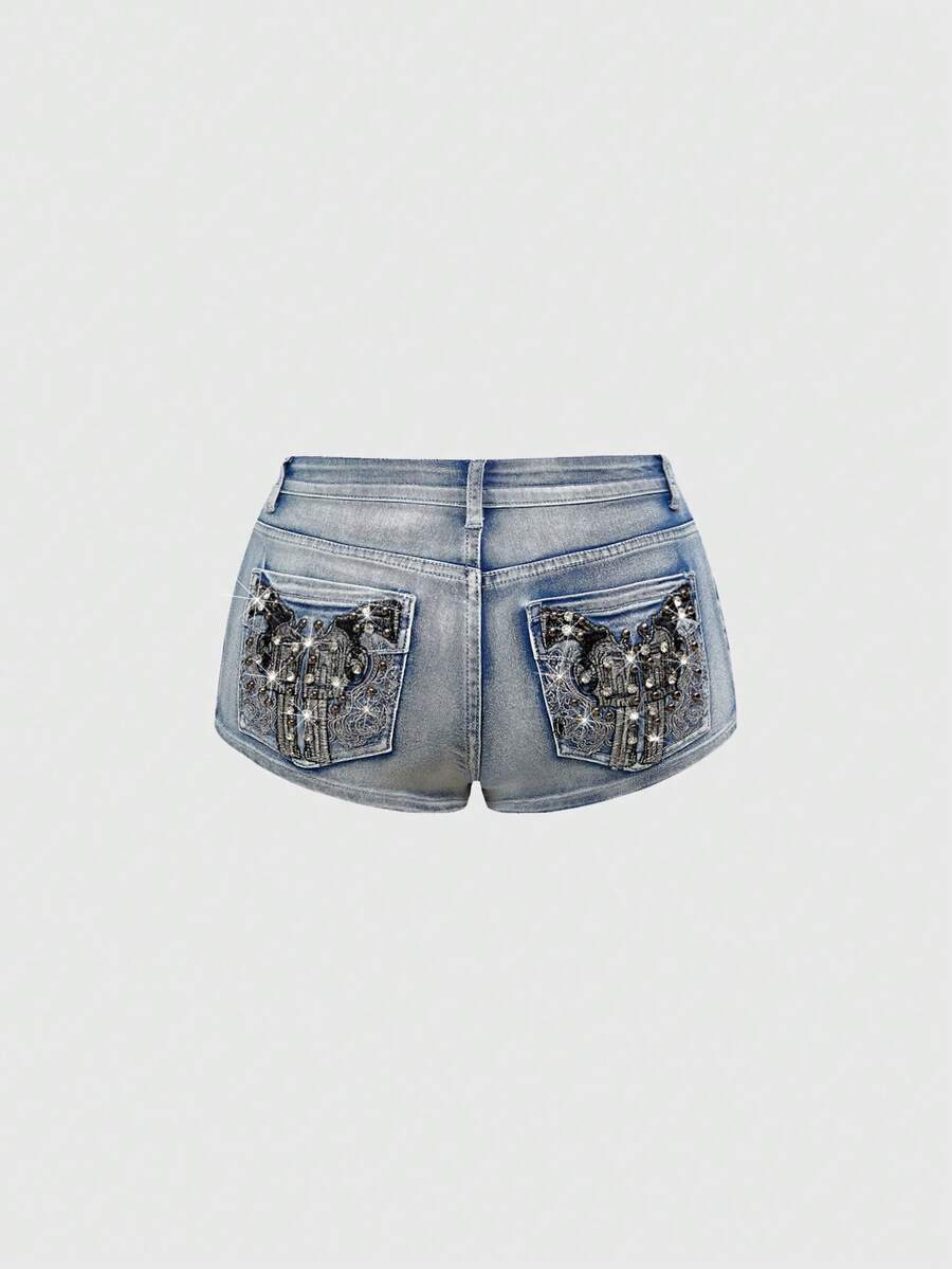 Women's ultra low waist skort with mini shorts length, zipper fly, pockets, pistol embroidery, and rhinestone details