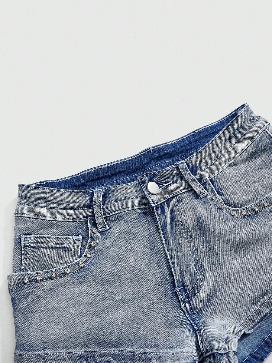 Women's ultra low waist skort with mini shorts length, zipper fly, pockets, pistol embroidery, and rhinestone details
