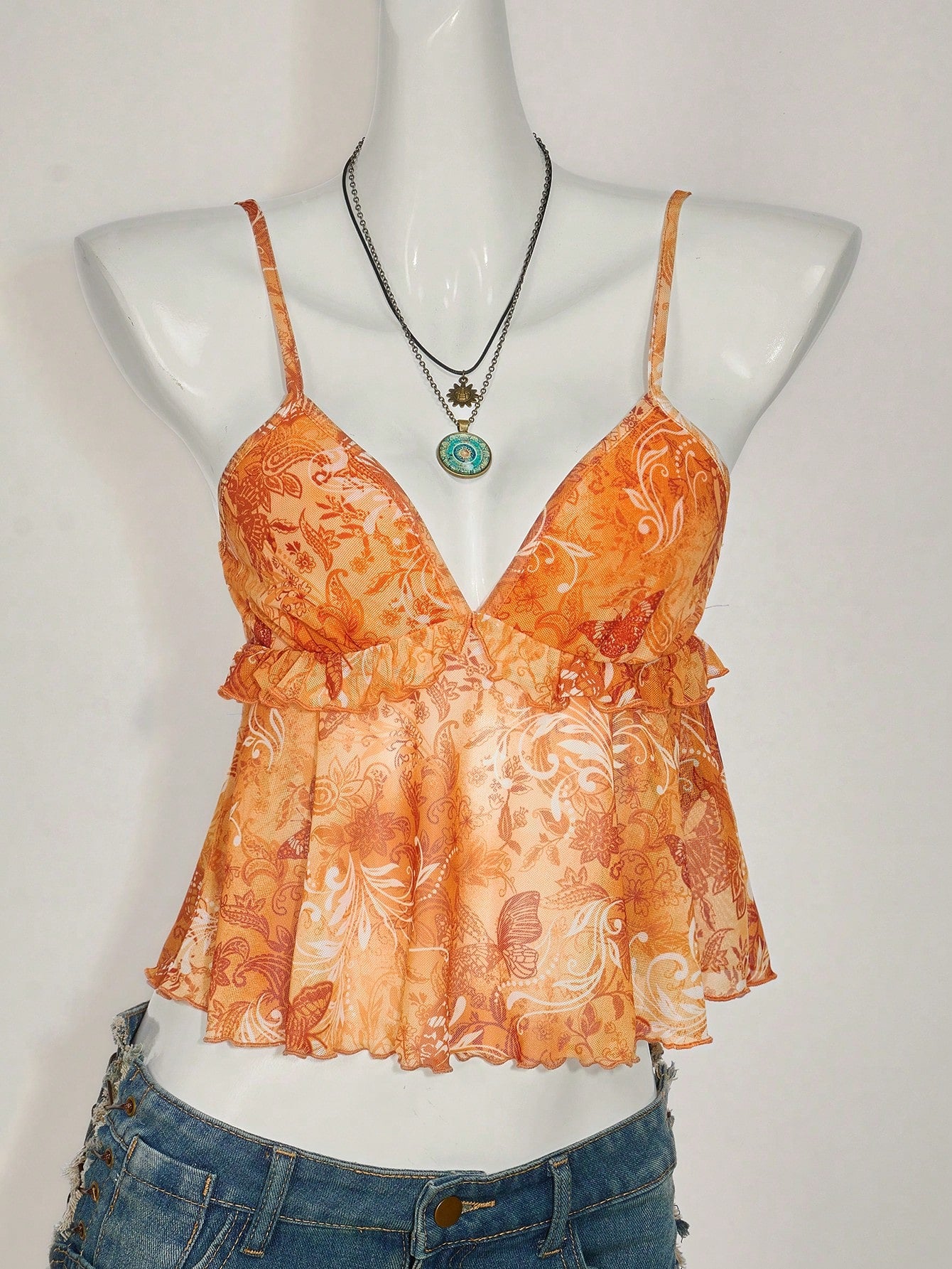 Floral multicolor mesh spaghetti strap cami tank top with backless design, ruffle hem, lettuce trim, and flared long loose fit.