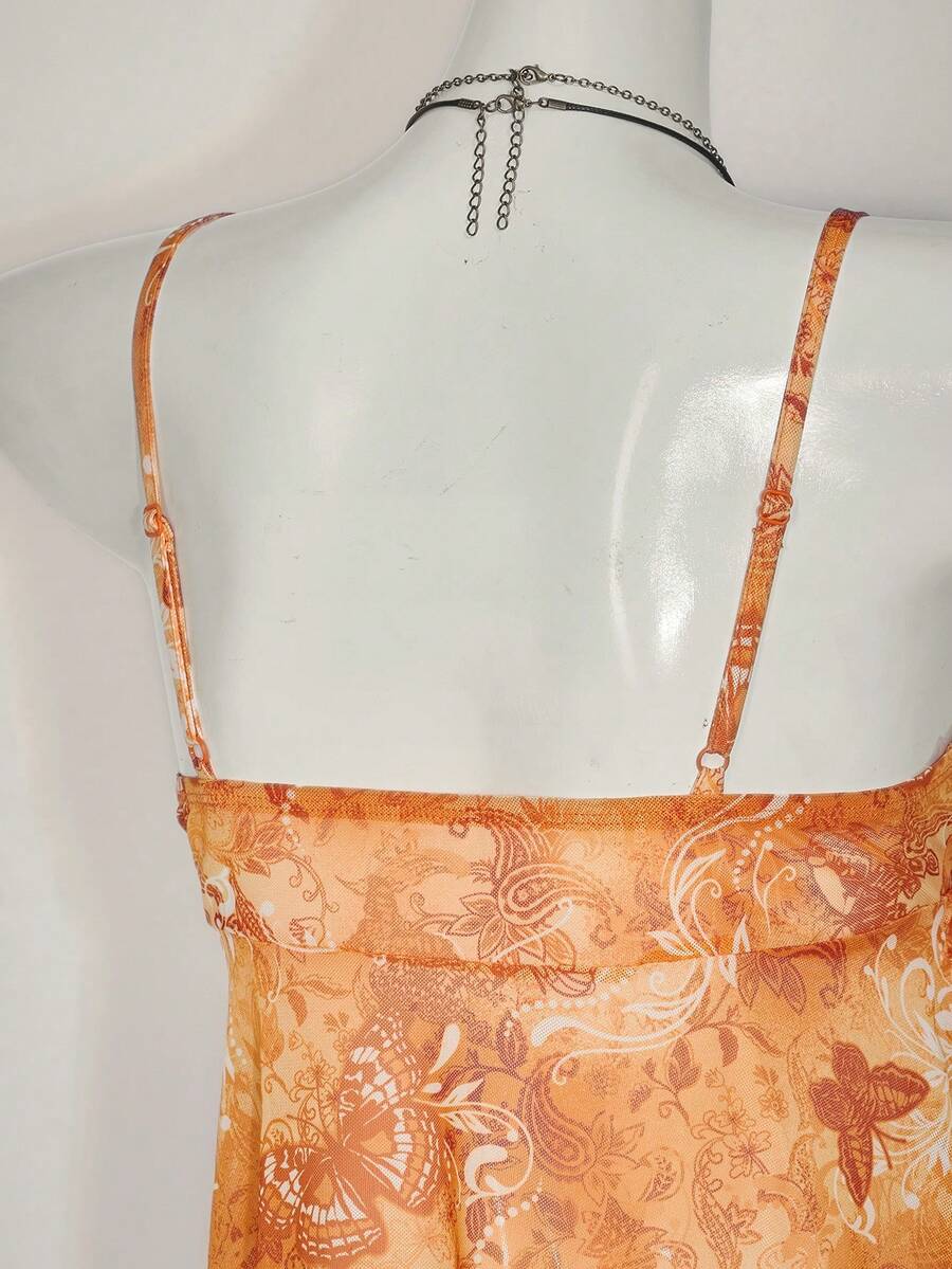 Floral multicolor mesh spaghetti strap cami tank top with backless design, ruffle hem, lettuce trim, and flared long loose fit.