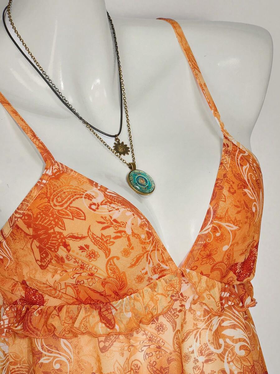Floral multicolor mesh spaghetti strap cami tank top with backless design, ruffle hem, lettuce trim, and flared long loose fit.
