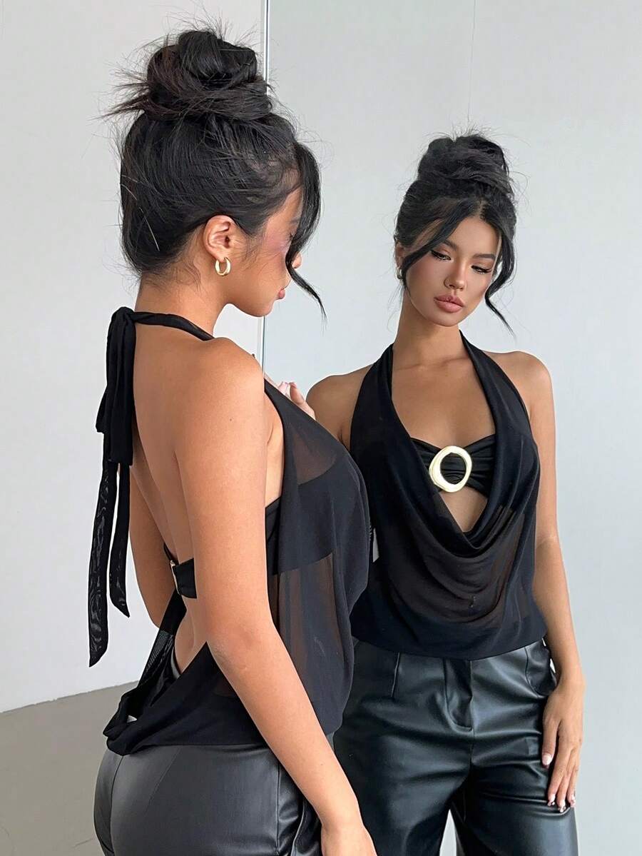 Brown and white polka dot semi-sheer halter camisole top with a plunging neckline, backless design, draped front, and metallic studded embellishments.