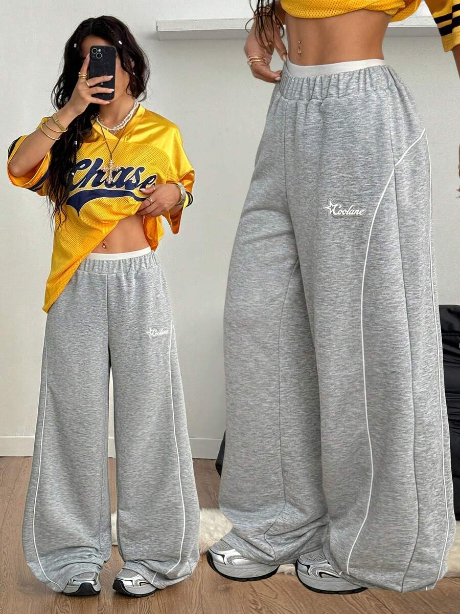 Grey patched baggy joggers with elastic mid-waist and loose straight leg fit