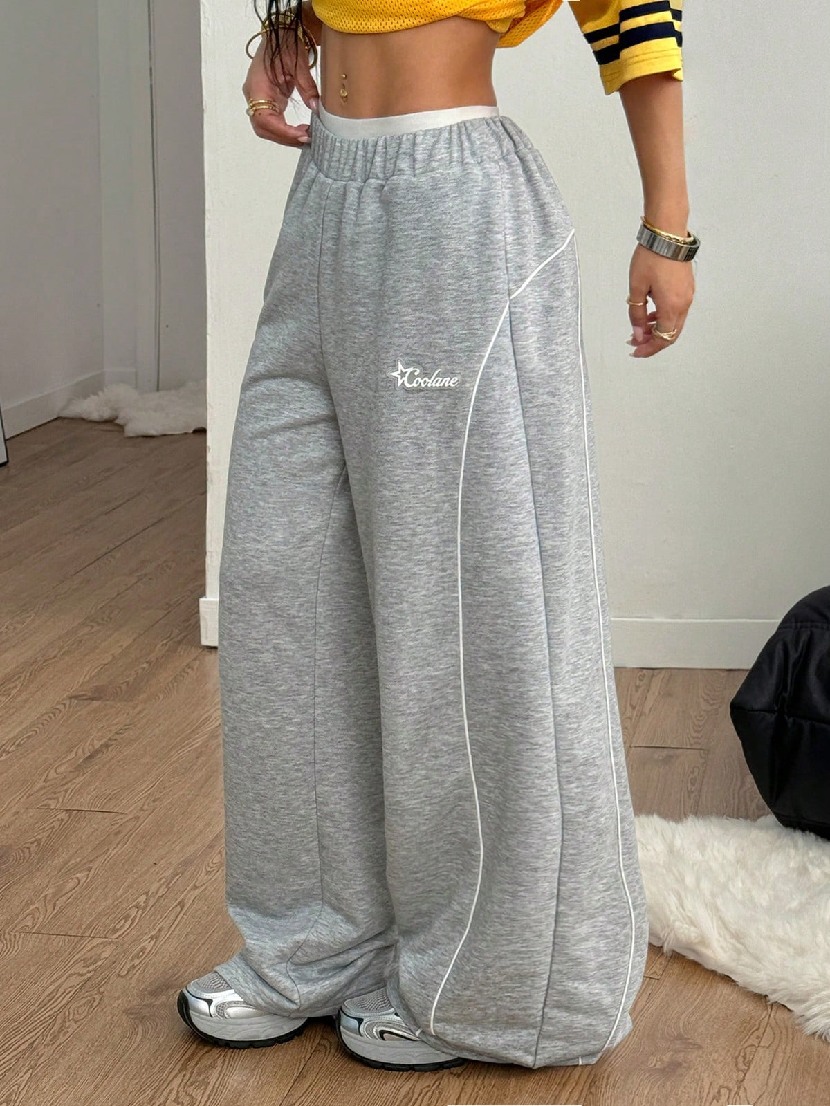 Grey patched baggy joggers with elastic mid-waist and loose straight leg fit