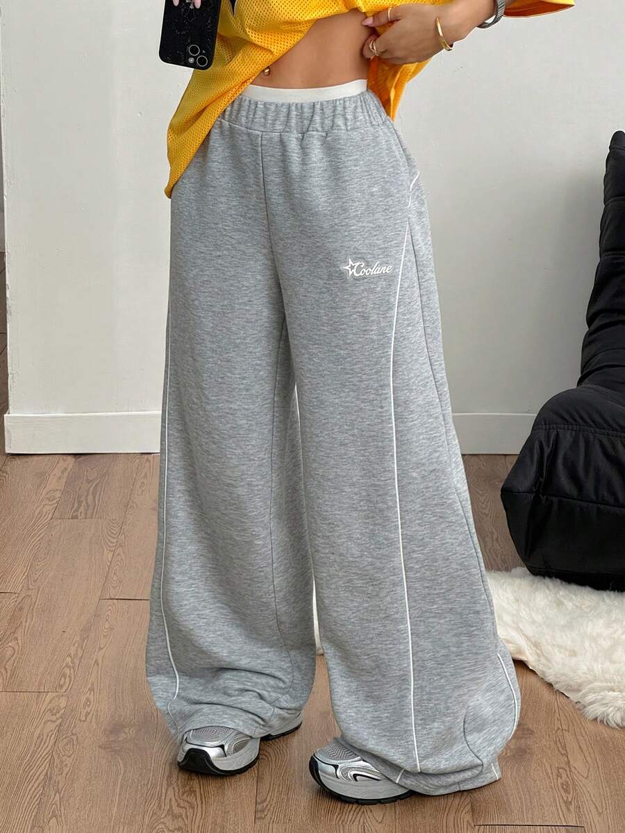 Grey patched baggy joggers with elastic mid-waist and loose straight leg fit