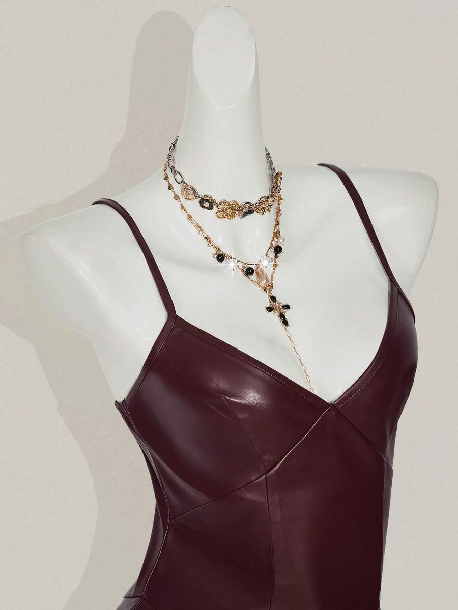 Women's Y2K PU leather mini dress with spaghetti straps, V-neckline, backless design, zipper closure, high waist, slim A-line fit, and layered tiered hem.