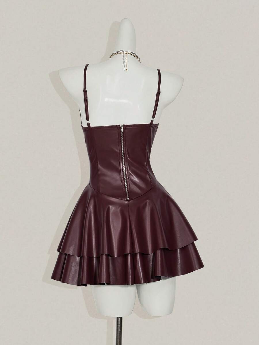 Women's Y2K PU leather mini dress with spaghetti straps, V-neckline, backless design, zipper closure, high waist, slim A-line fit, and layered tiered hem.