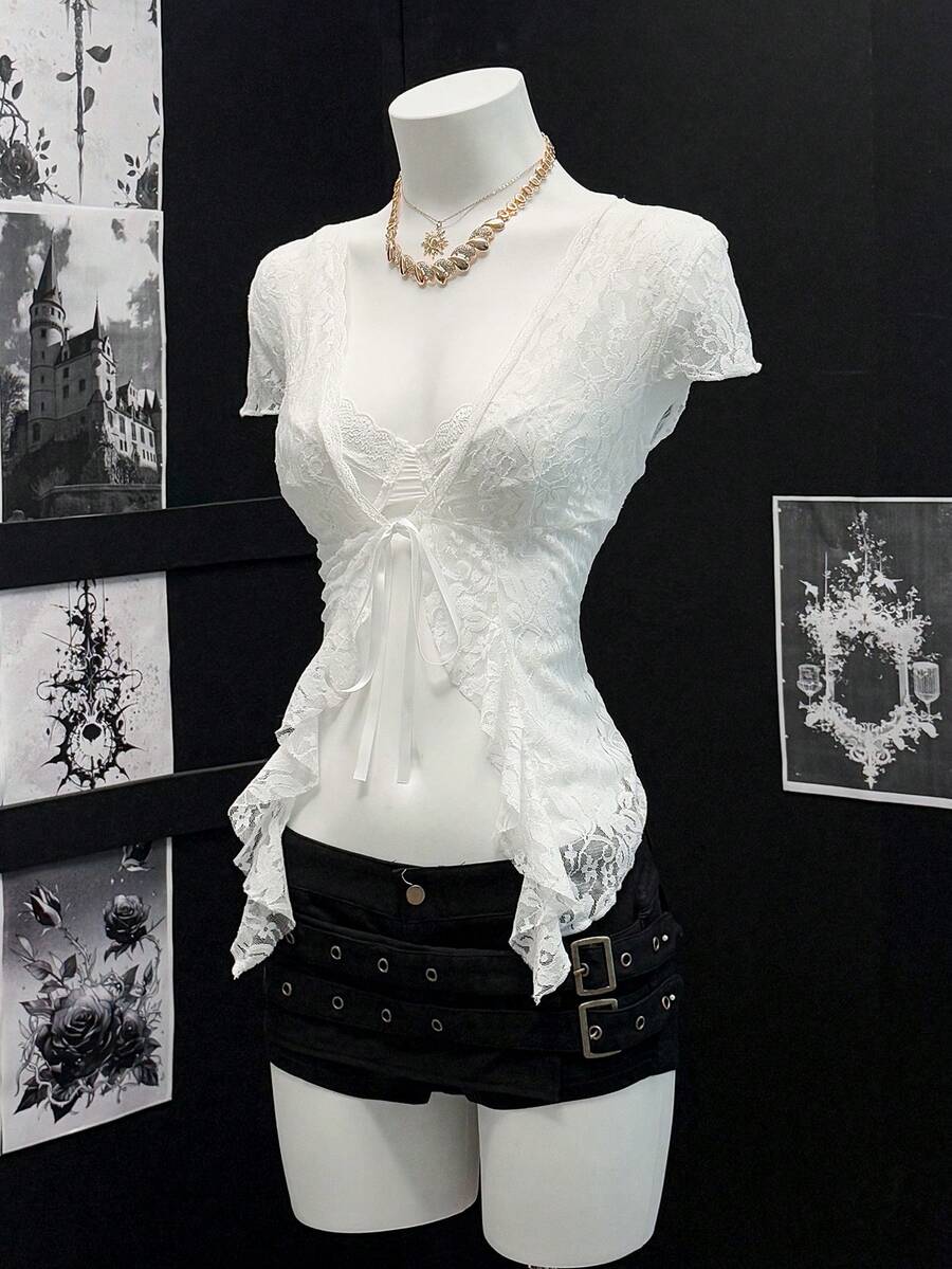 Women's semi-sheer deep V-neck top featuring cap sleeves, contrast lace trimming, and a lace-up front detail.