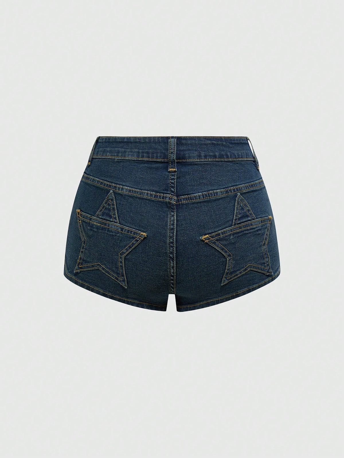 Women's ultra low waist mini shorts with back pockets, zipper fly, button detail, random print, and star patch in a grunge punk Y2K style.
