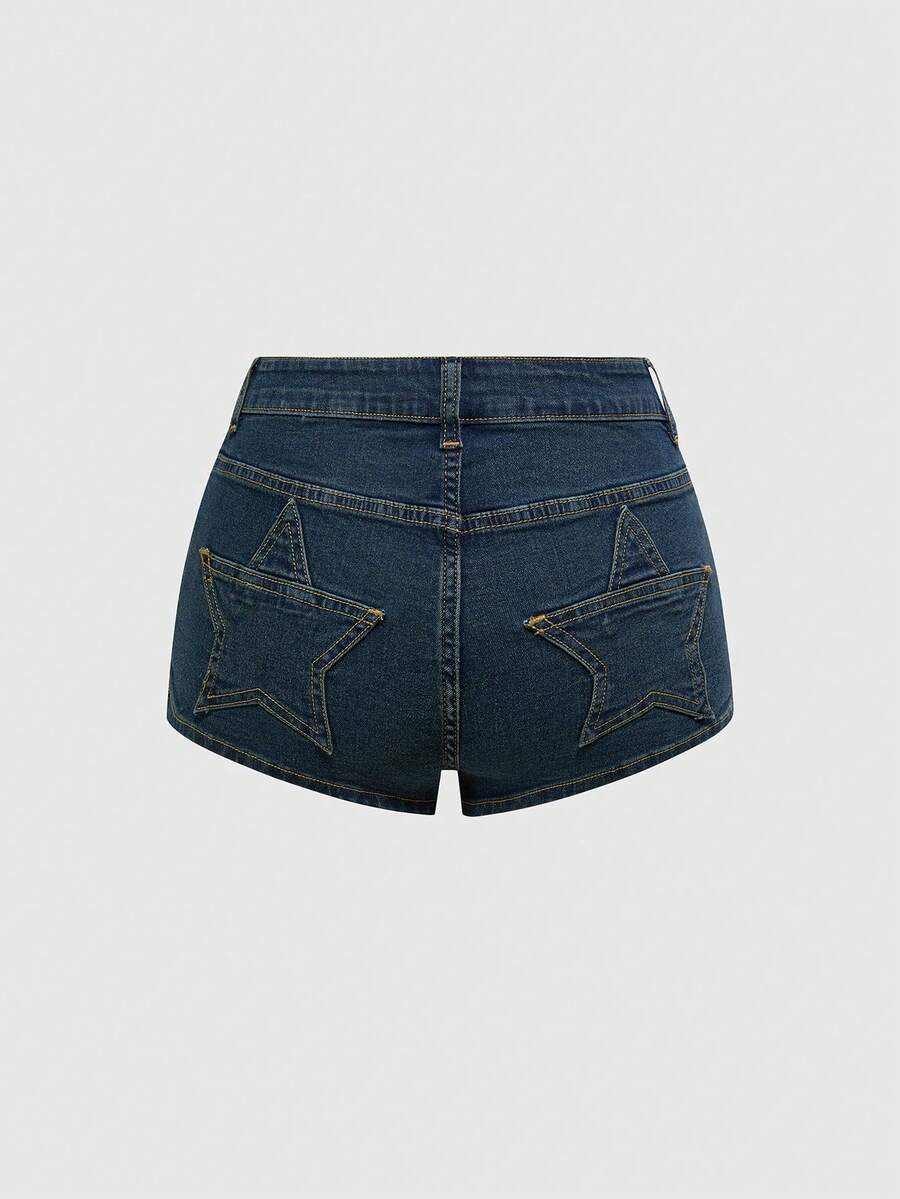 Women's ultra low waist mini shorts with back pockets, zipper fly, button detail, random print, and star patch in a grunge punk Y2K style.