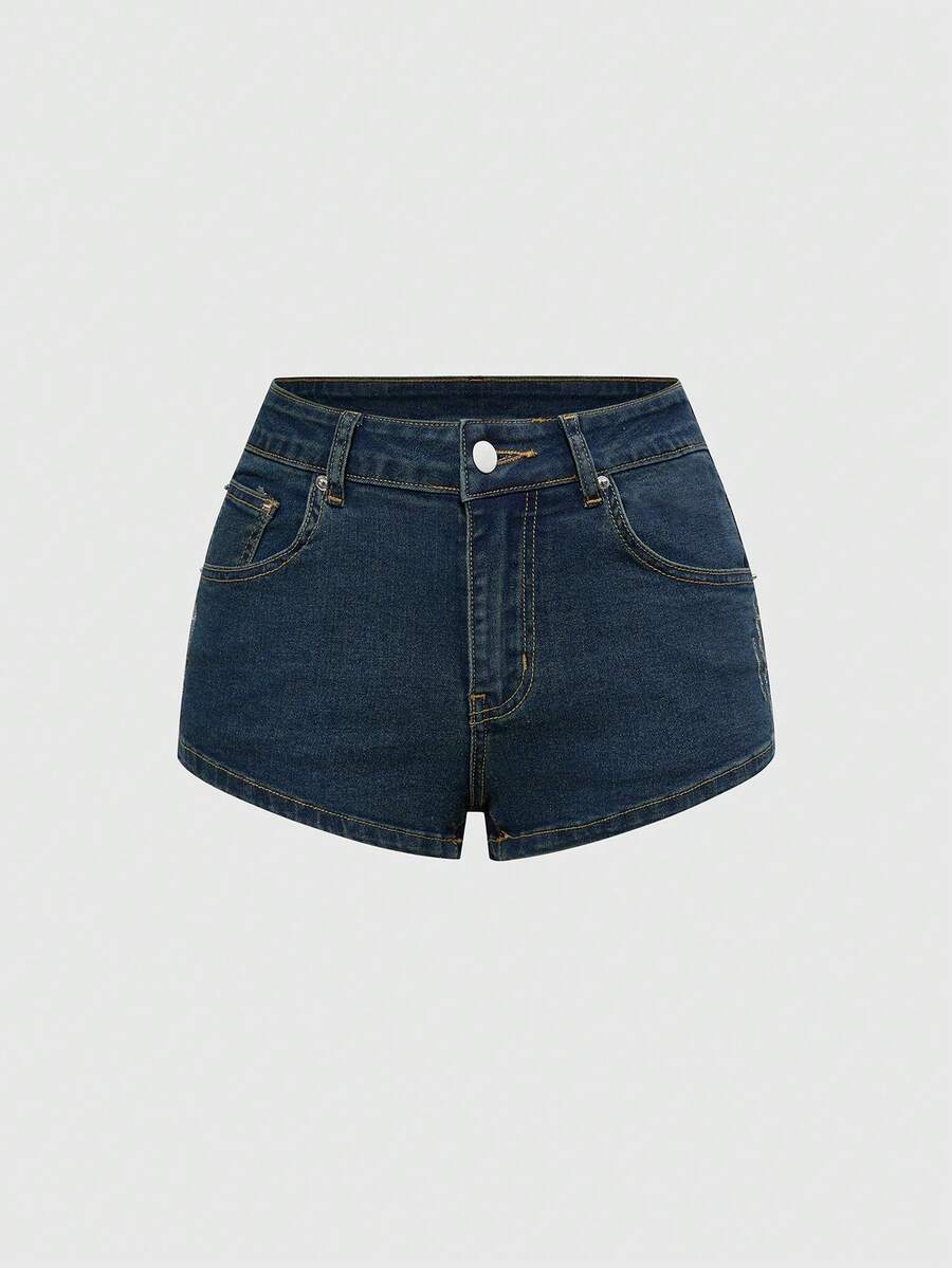 Women's ultra low waist mini shorts with back pockets, zipper fly, button detail, random print, and star patch in a grunge punk Y2K style.