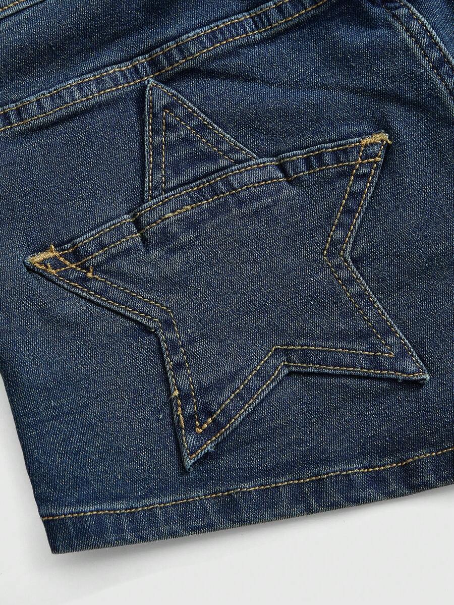 Women's ultra low waist mini shorts with back pockets, zipper fly, button detail, random print, and star patch in a grunge punk Y2K style.