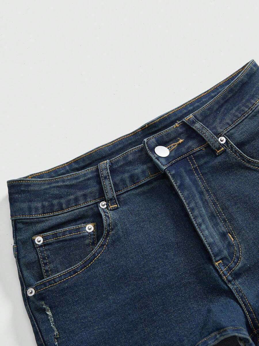 Women's ultra low waist mini shorts with back pockets, zipper fly, button detail, random print, and star patch in a grunge punk Y2K style.