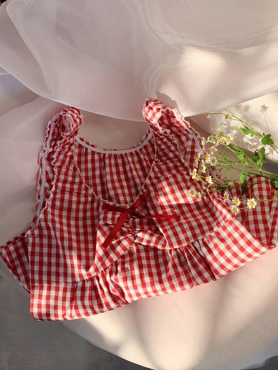 Women's red gingham smocked tank top with scoop neck, ruffle hem, and bow knot detail