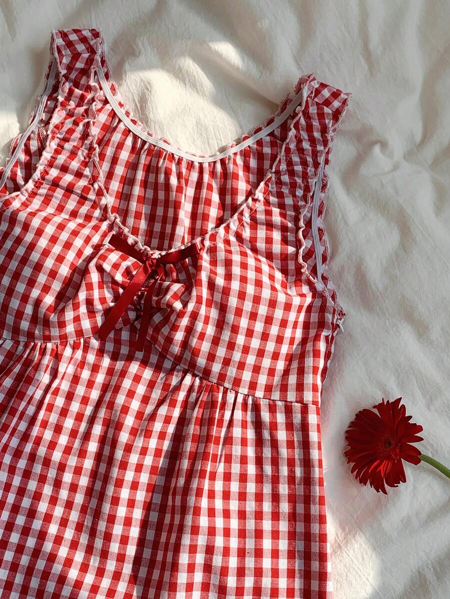 Women's red gingham smocked tank top with scoop neck, ruffle hem, and bow knot detail