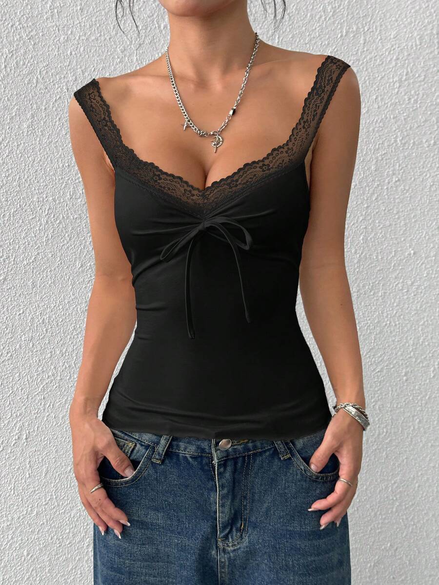 Women's slim fit casual camisole featuring wide shoulder straps, contrast lace trim, a front knot, and ruched details.