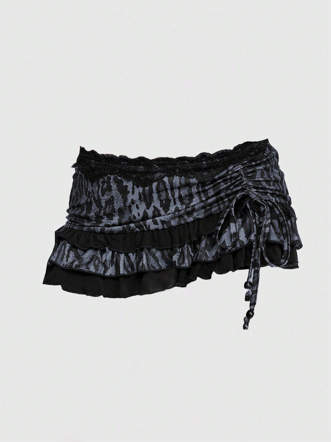 Women's low-waist leopard print mini skirt with drawstring tie-up, ruched detail, layered ruffle hem, and asymmetric grunge punk styling