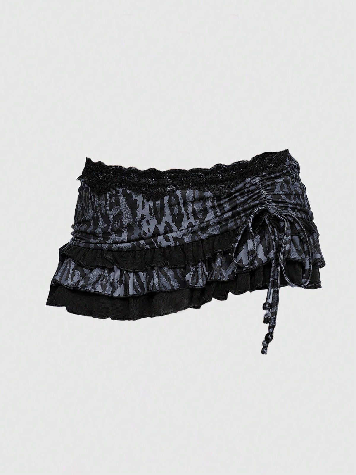 Women's low-waist leopard print mini skirt with drawstring tie-up, ruched detail, layered ruffle hem, and asymmetric grunge punk styling
