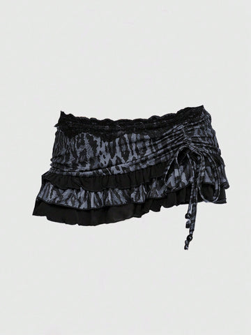 Women's low-waist leopard print mini skirt with drawstring tie-up, ruched detail, layered ruffle hem, and asymmetric grunge punk styling