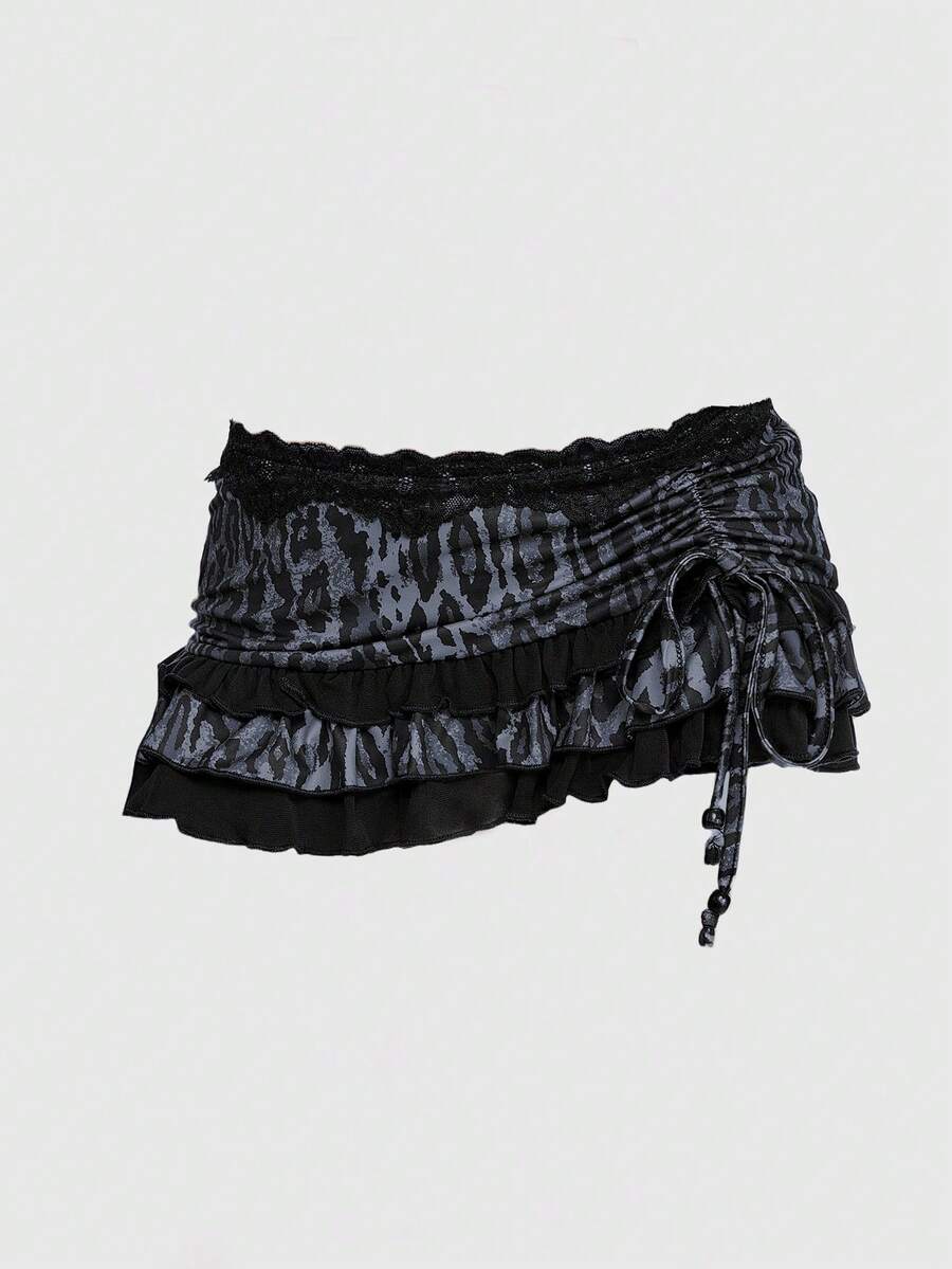 Women's low-waist leopard print mini skirt with drawstring tie-up, ruched detail, layered ruffle hem, and asymmetric grunge punk styling