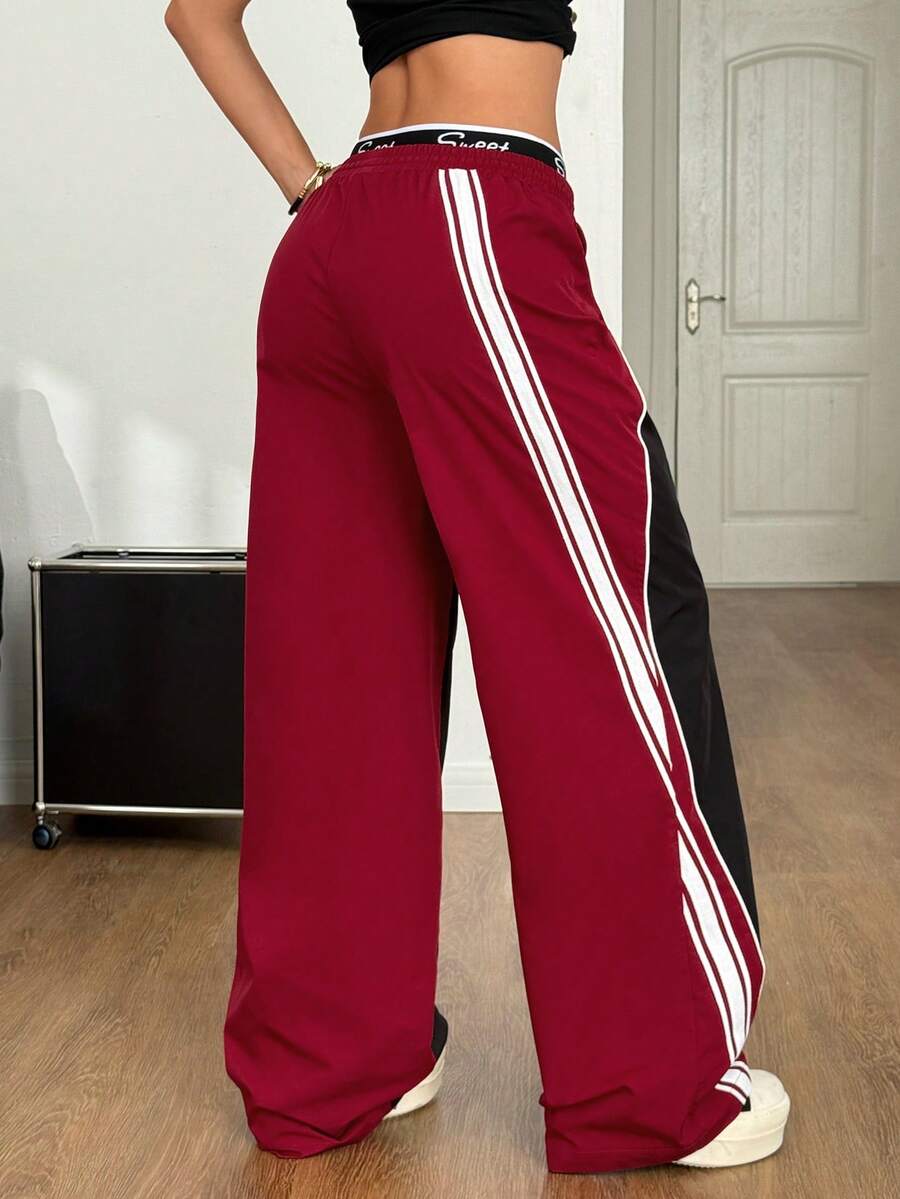 Women's loose fit straight leg pants in black and white with banded texture design, low drawstring waist, and pockets.