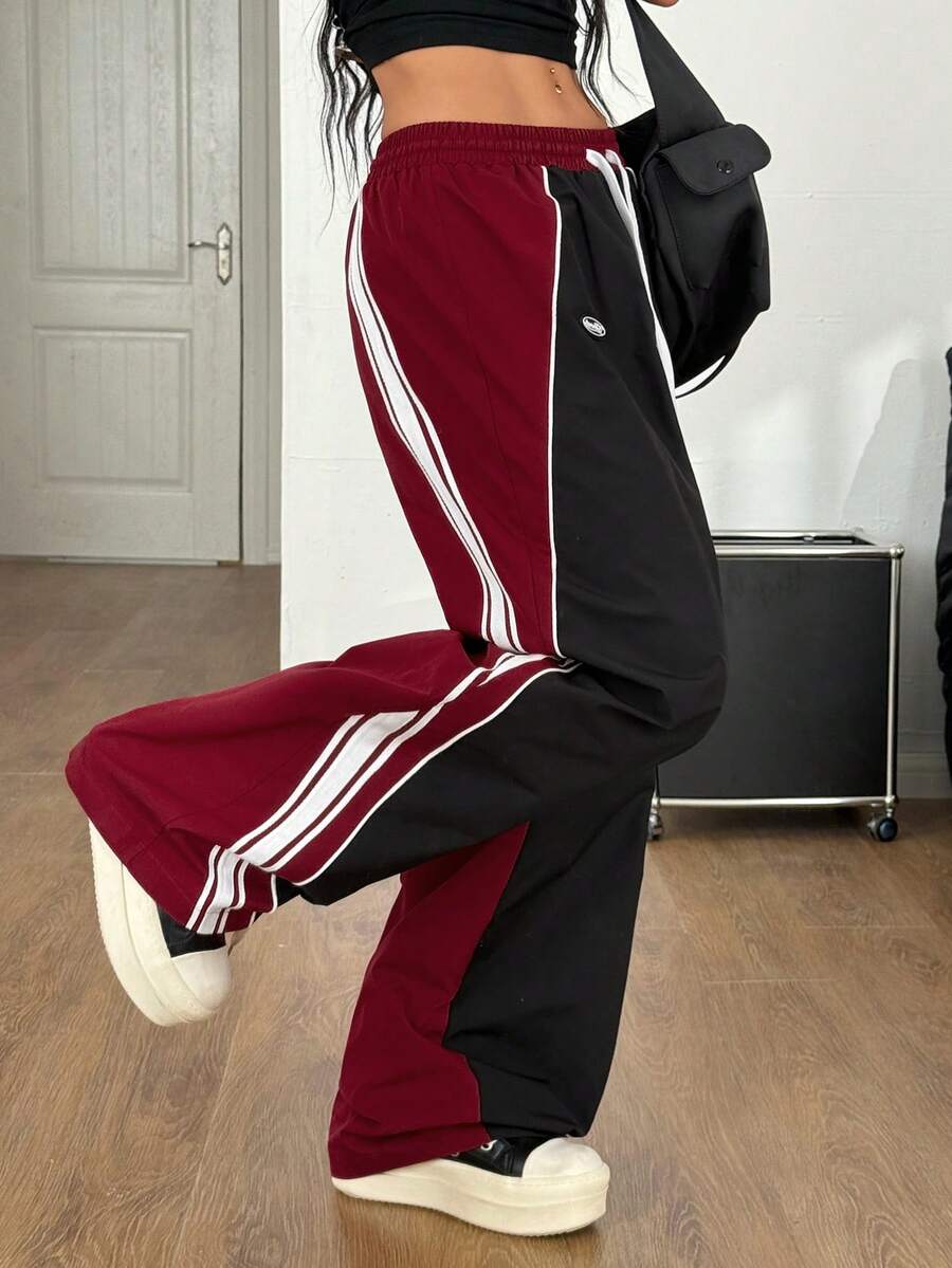 Women's loose fit straight leg pants in black and white with banded texture design, low drawstring waist, and pockets.