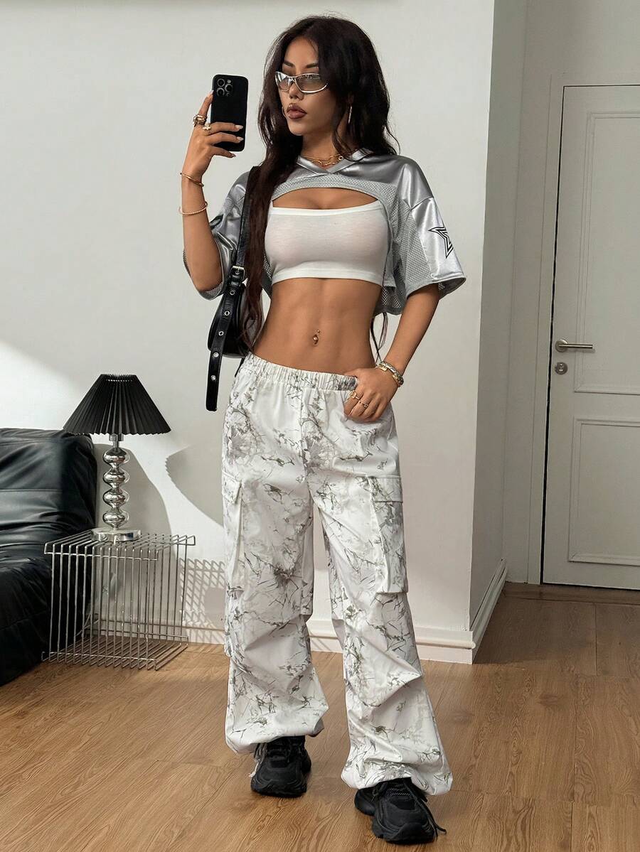 Front view of a women's black and white striped short sleeve crop top with a round neckline and semi-sheer knit finish.