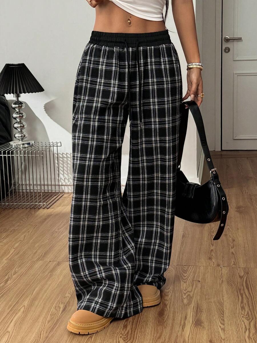 Women's casual black and white checked wide leg pants featuring an elastic drawstring waistband and a loose straight leg fit.