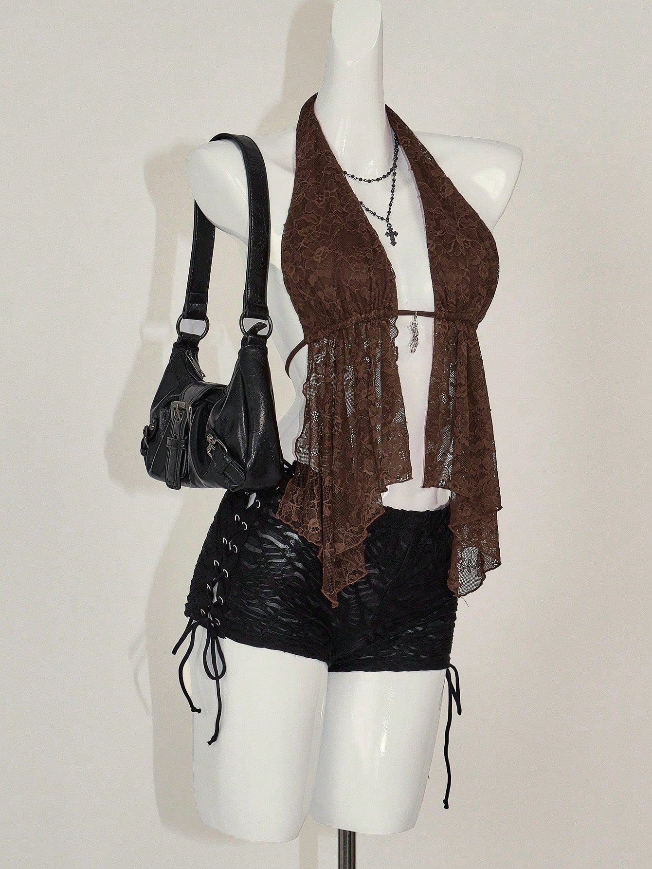 Women's lace halter neck camisole with backless styling, asymmetrical hem, slim fit, and semi-sheer lined design