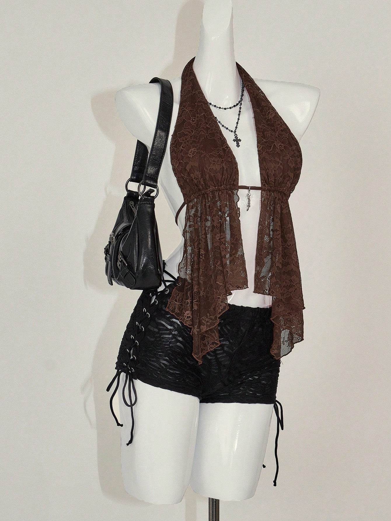 Women's lace halter neck camisole with backless styling, asymmetrical hem, slim fit, and semi-sheer lined design