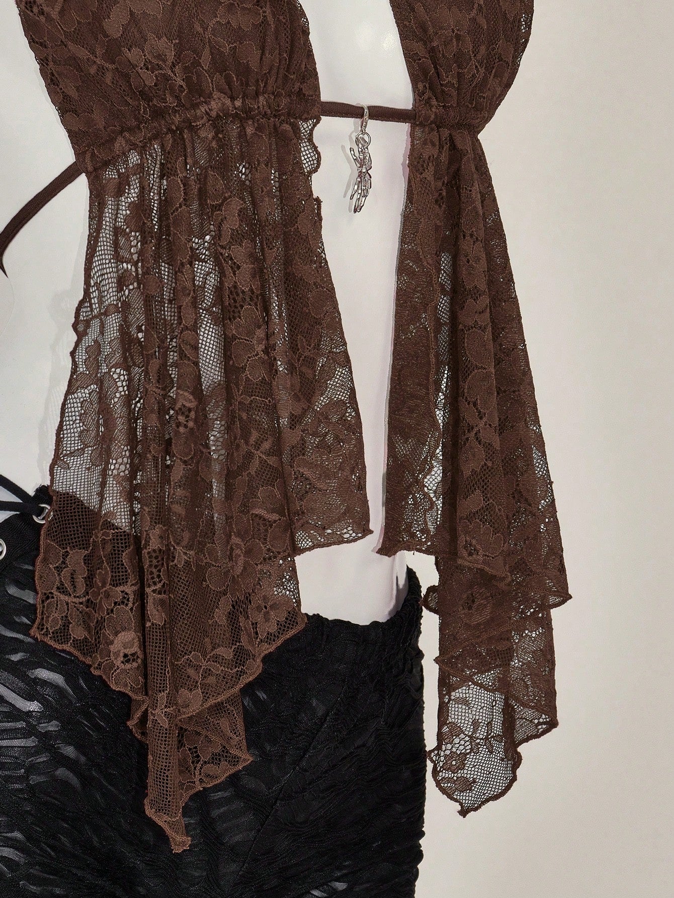 Women's lace halter neck camisole with backless styling, asymmetrical hem, slim fit, and semi-sheer lined design