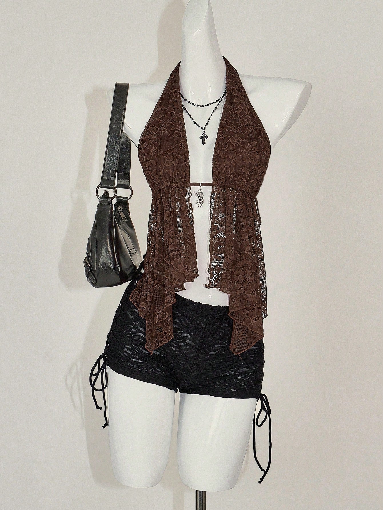 Women's lace halter neck camisole with backless styling, asymmetrical hem, slim fit, and semi-sheer lined design
