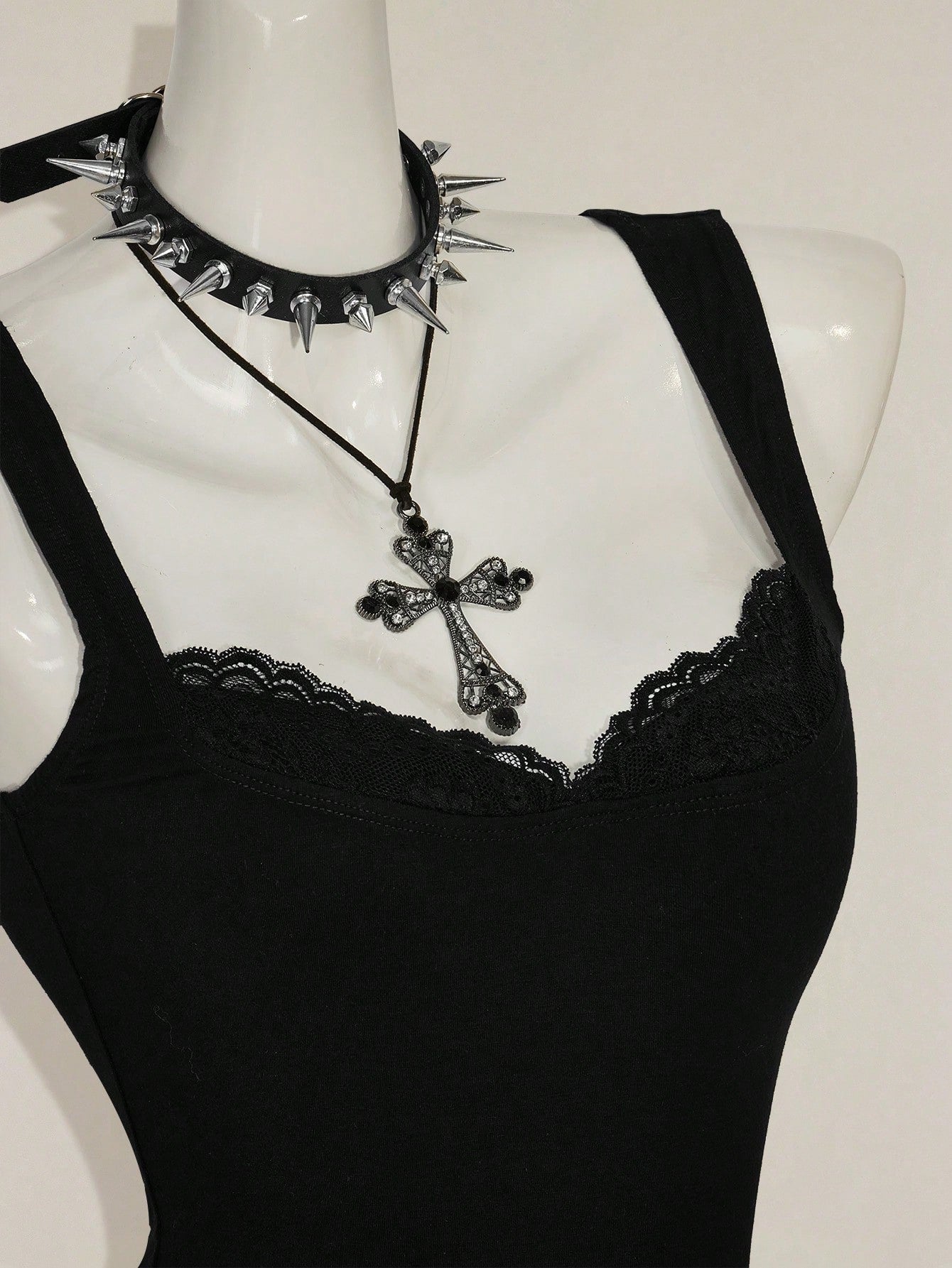 Black sleeveless crop cami top with wide straps, contrast lace trim, rib-knit texture, slim fit, and regular hem