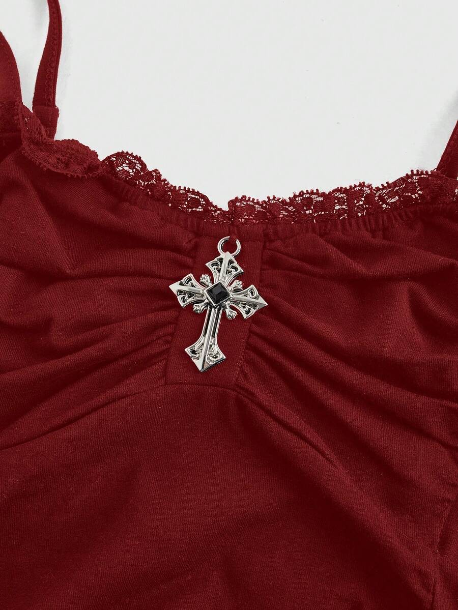 Black gothic spaghetti strap tank top for women featuring contrast lace patchwork, ruched frill details, and a cross pendant accent in a slim fit knitted fabric.