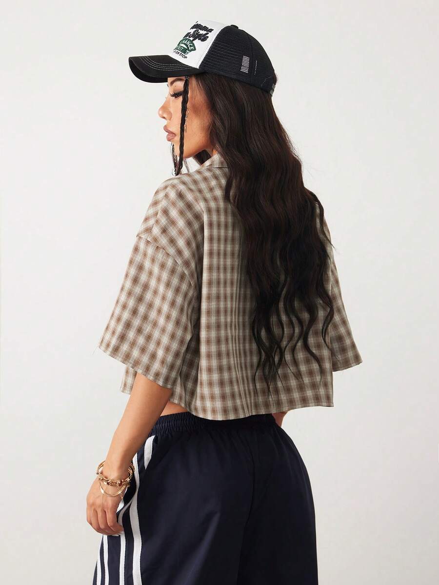 Women's plaid crop shirt with button front, chest pocket, short sleeves, and loose casual fit.