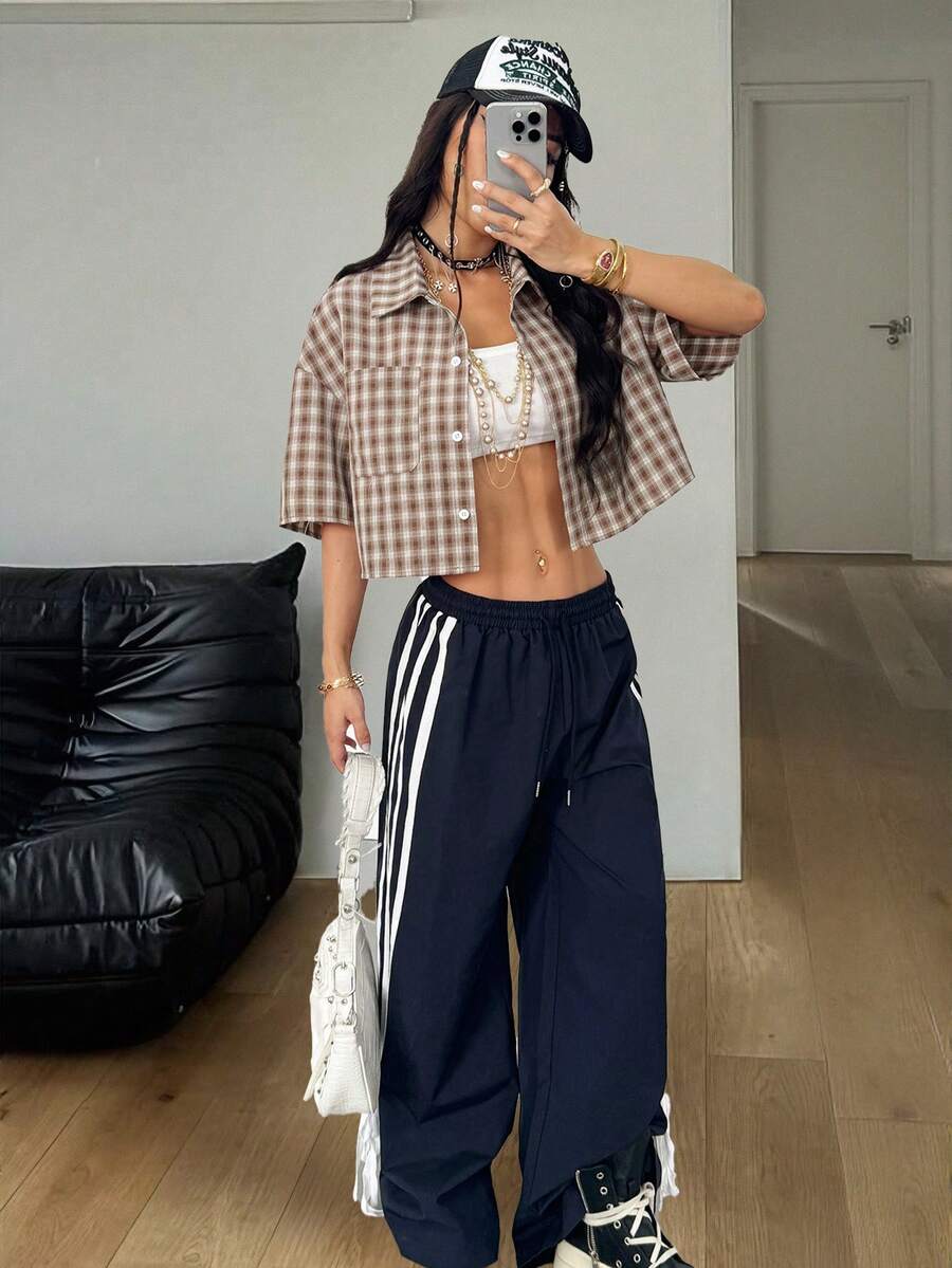 Women's plaid crop shirt with button front, chest pocket, short sleeves, and loose casual fit.