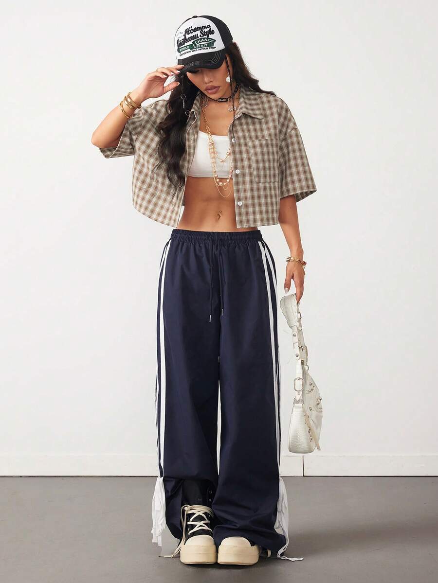 Women's plaid crop shirt with button front, chest pocket, short sleeves, and loose casual fit.