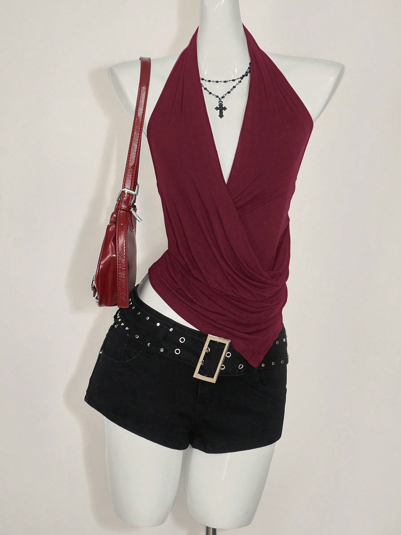 Women's asymmetrical hem halter tank top with draped neckline, backless wrap styling, and grommet eyelet details